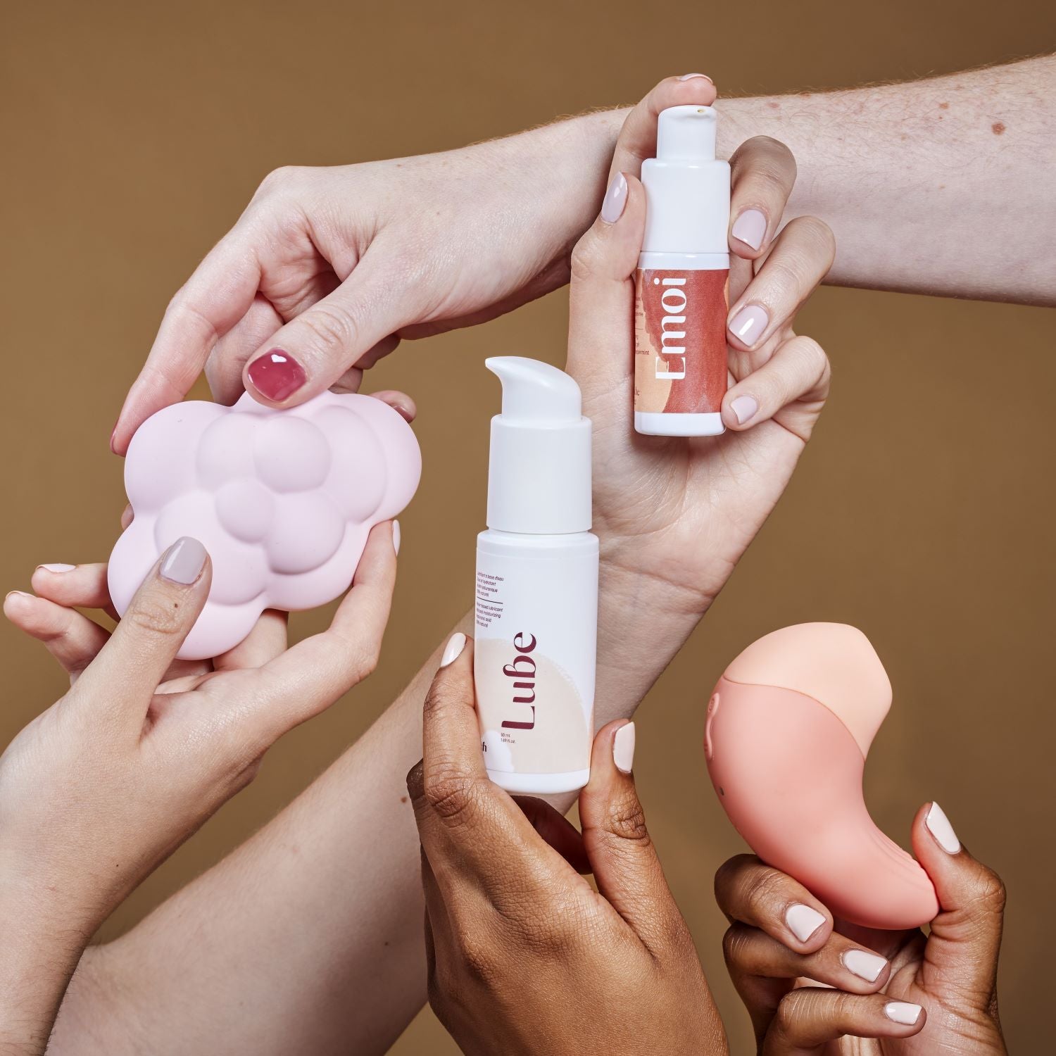 Detail of Bouche Bée box containing Ona clitoral stimulator sextoy, nuee vibro tactile low frequency, emoi stimulating exciting orgasmic gel and lube natural lubricant 100% hyaluronic acid in hands.